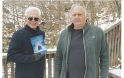 Author Lawrence P. O’Brien (right) stands with Old Chelsea councillor Donald Déry in front of the waterfall near the burial site of the Wright caravan’s leader, shortly after the release of Swallowing the Muskellunge. Photo: Courtesy