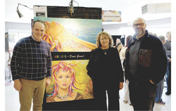 Federal Transport Minister Steven MacKinnon, left, poses with Artist of the Year Doris Genest in front of two of her works during his visit to the Art Sale organized by Arts Visuels de Gatineau on Saturday, April 25, 2026, at the Tétreau Community Centre. They are accompanied by Adrian Corbo, City Councillor for the Manoir-des-Trembles-Val-Tétreau District with Action Gatineau. Photo: Christian Rochefort