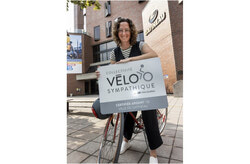 Catherine Craig St-Louis, President of the Commission on Transportation, Sustainable Travel and Safety, posing with the Silver VÉLOSYMPATIQUE Collectivity Certification in front of City Hall. Photo: Ville de Gatineau.